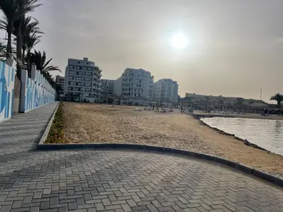 a sandy beach with buildings in the background at Scandic 1 in Hurghada