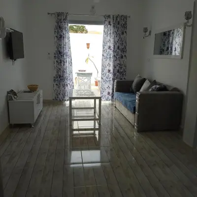 a living room with a couch and a table at desert pearl beautiful cosy new home in Luxor