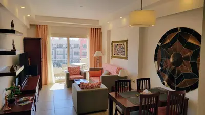 a living room with a couch and a table at Oyster Bay Beach Resort - Luxury Serviced Condo in Marsa Alam City