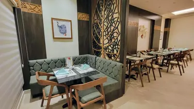 a row of tables and chairs in a restaurant at Oyster Bay Beach Resort - Luxury Serviced Condo in Marsa Alam City
