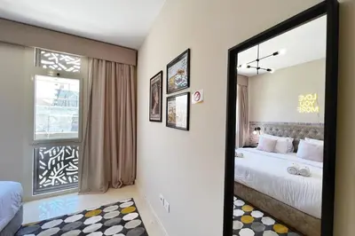 a bedroom with two beds and a mirror at Enticing & Earthy 1 BDR Mangroovy Free Pool & Beach Access in Hurghada