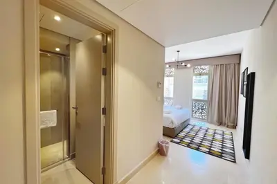 a hallway with a door leading to a bedroom at Enticing & Earthy 1 BDR Mangroovy Free Pool & Beach Access in Hurghada