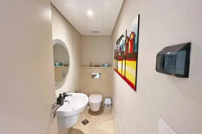 a bathroom with a sink and a tv on the wall at Proper & Plush 1 BDR Mangroovy Free Pool & Beach Access in Hurghada