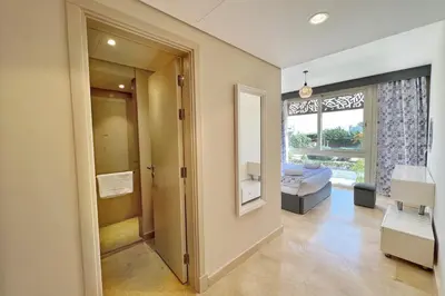 a living room with a door leading to a bedroom at Proper & Plush 1 BDR Mangroovy Free Pool & Beach Access in Hurghada