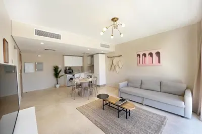 a living room with a couch and a table at Perky 1 BDR Mangroovy Free Pool & Beach Access in Hurghada