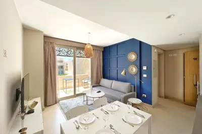 a living room with blue walls and a couch at Modern & Mellow 1 BDR Mangroovy Free Beach & Pool Access in Hurghada
