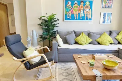 a living room with a couch and a coffee table at Sparky & Summery 2 BDR Mangroovy Free Beach & Pool Access in Hurghada