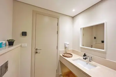 a bathroom with a sink and a mirror at Radiant & Ravishing 2 BDR Mangroovy Free Beach & Pool Access in Hurghada