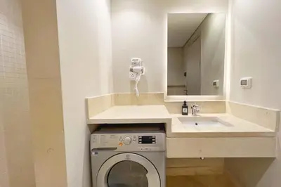 a bathroom with a washing machine and a sink at Charming 2BDR w Sea & Pool View Free Beach & Pool Access in Hurghada