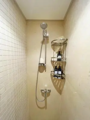 a shower in the corner of a bathroom at Charming 2BDR w Sea & Pool View Free Beach & Pool Access in Hurghada