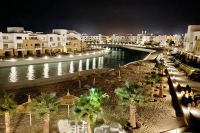 a view of a river with buildings and palm trees at Lagoonfront Easy 1BDR Swan Lake El Gouna in Hurghada