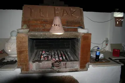 a brick fireplace with a bell on top of it at A Beautiful, Family-owned Penthouse Apartment, Overlooking the Red Sea Hurghada in Hurghada