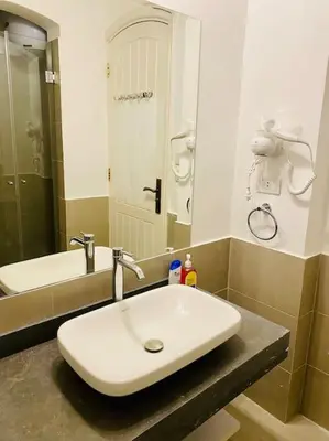 a bathroom with a white sink and a mirror at Brand New 1-BR Apt @West Golf- El Gouna W/ a View! in Hurghada