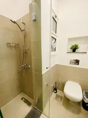 a bathroom with a shower with a toilet and a sink at Brand New 1-BR Apt @West Golf- El Gouna W/ a View! in Hurghada