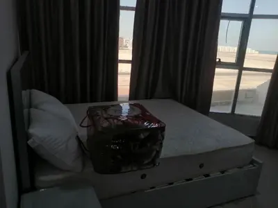 a bedroom with a bed with a large window at 402 A in Hurghada