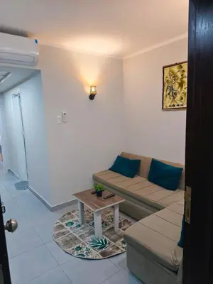 a living room with a couch and a coffee table at Scandic Resort Apartments in Hurghada