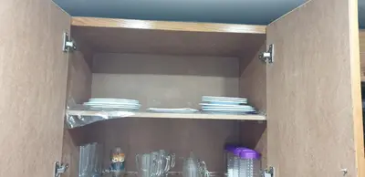 a cupboard with plates and dishes in it at Scandic Resort Apartments in Hurghada