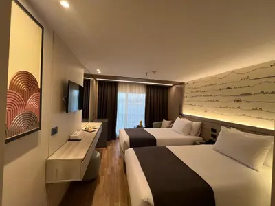 a hotel room with two beds and a television at Nile Cruise 5 Stars From Luxor And Aswan 3&4 Nights in Aḑ Ḑab‘īyah