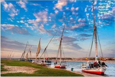 a group of boats are docked in the water at Kayan Guest House in Aswan