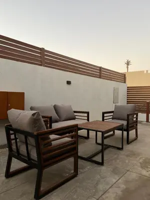 a patio with two benches and a table and a couch at 2 Bedroom villa with private heated pool in Gouna in Hurghada