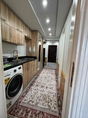 a kitchen with a washing machine and a rug at Scandic Rezort in Hurghada