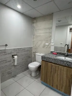 a bathroom with a toilet and a sink at Scandic Rezort in Hurghada