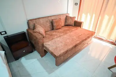 a brown couch sitting in a living room at Kana Kato in Aswan