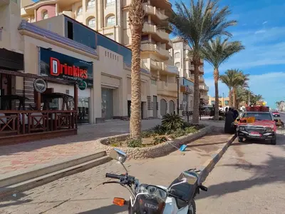 a motorcycle parked on a street with a fire truck at Florenza khamsin aprt F7 in Hurghada