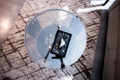 a glass table with a cell phone on a plate at El Gouna Elite Worldwide Sea & Garden Residences - Hurghada, Egypt in Hurghada