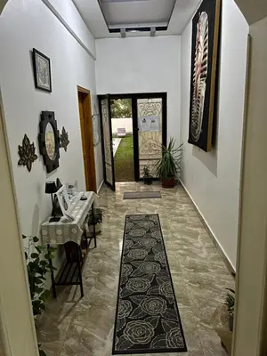 a hallway with a table and chairs in a house at Villa Set ma'at Nile view in Luxor