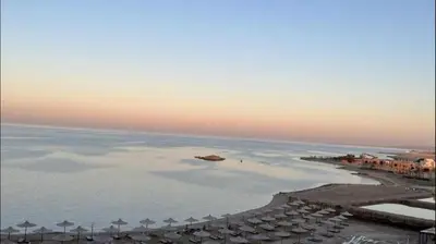 an aerial view of a beach with umbrellas and the ocean at Casablanca beach resort, first line, with private beach and swimming pools,hurghada in Hurghada
