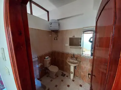 a small bathroom with a toilet and a sink at Lucky House in Luxor