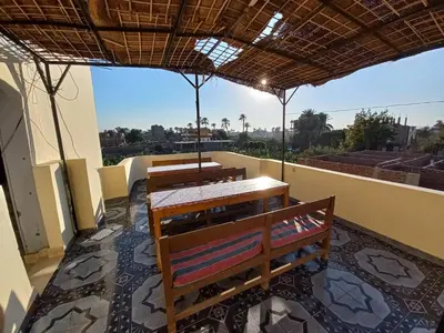 a group of benches sitting on a balcony at Lucky House in Luxor