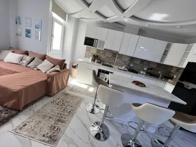 a living room with a couch and a kitchen at GRACELAND Apartment in Hurghada city centre in Hurghada