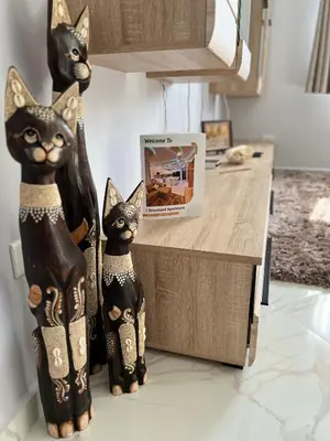 two figurines of cats standing on a kitchen counter at GRACELAND Apartment in Hurghada city centre in Hurghada
