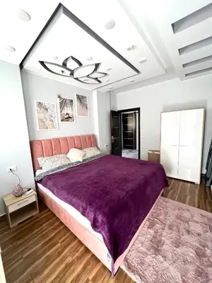 a bedroom with a large purple bed in a room at GRACELAND Apartment in Hurghada city centre in Hurghada