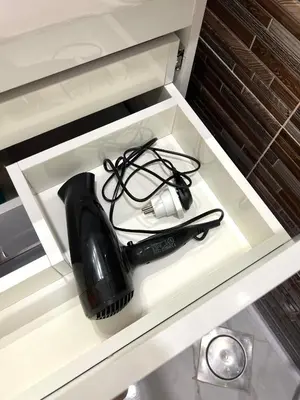 a black hair dryer sitting in a drawer at GRACELAND Apartment in Hurghada city centre in Hurghada