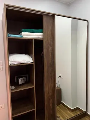 a closet with a mirror in a room at GRACELAND Apartment in Hurghada city centre in Hurghada