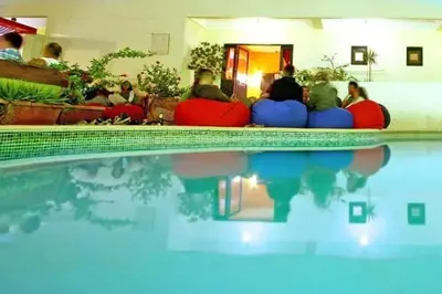 a group of people sitting around a swimming pool at L'Oasis de Safaga Hotel in Hurghada