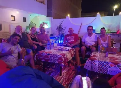 a group of people sitting in a room with tables at L'Oasis de Safaga Hotel in Hurghada