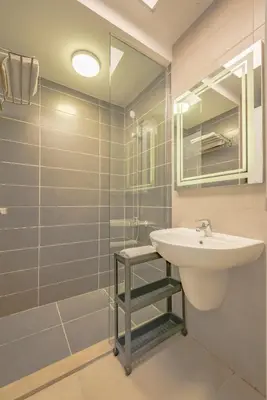 a bathroom with a sink and a glass shower at Modern 1-Bedroom Apartment in G-Cribs, El Gouna, pool access in Hurghada