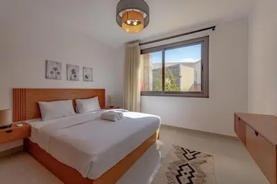 a bedroom with a large bed and a window at Modern 1-Bedroom Apartment in G-Cribs, El Gouna, pool access in Hurghada