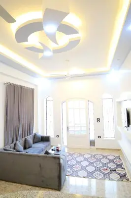 a living room with a couch and a ceiling at Tomorrow Land villa in Luxor