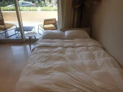 a white bed in a room with a window at Mangroovy - 1BR Glamorous Gouna view condo in Hurghada
