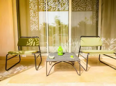 two chairs and a table in a room at Mangroovy - 1BR Glamorous Gouna view condo in Hurghada