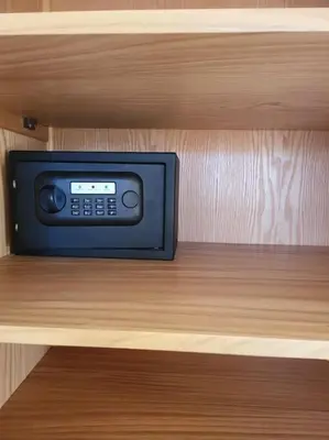 a small television sitting on a shelf in a cabinet at Mangroovy - 2BR Marvelous Pool View Apartment in Hurghada