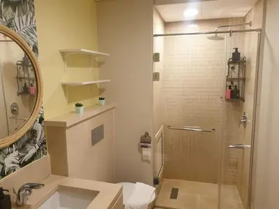 a bathroom with a shower and a sink at Mangroovy - 1BR GF +2 wall beds Garden & Pool view in Hurghada