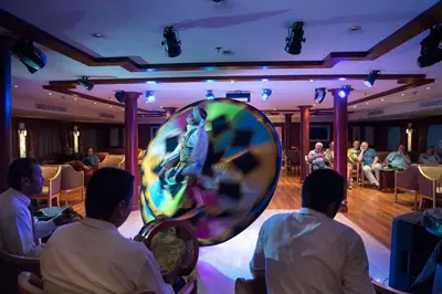 a group of men sitting in a room with a mirror at Nile Cruise 3 & 4 & 7 Nights in Luxor