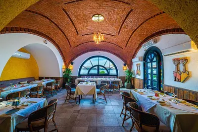 a restaurant with tables and chairs in a room at Sonesta Nouba Hotel Aswan in Aswan