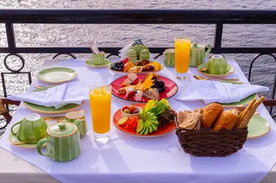a white table with plates of food and drinks at Sonesta Nouba Hotel Aswan in Aswan